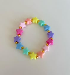 this bracelet is made with plastic stars and gold beads. please measure youre wrist and tell me you're size in a private message. (see announcement on my etsy home page on how to do it). Preppy Bracelets Star, Preppy Clay Bead Bracelets Star, Rainbow Star-shaped Bracelet For Gift, Star Bead Bracelet, Ideas Para Hacer Pulseras, Pulseras Aesthetic, Kandi Inspiration, Make Clay Beads, Diy Beaded Bracelets