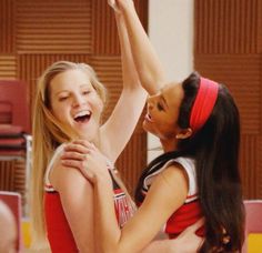 two girls are playing basketball and one has her arm around the other's neck