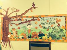 a bulletin board with an image of a boy in the tree and leaves on it