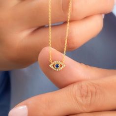 14k Gold and diamond evil eye necklace with sapphire, ruby and emerald center stone options. Diamond: 0.10 ct diamond Charm Measurements: 10 mm x 5 mm ( 0.4 inch. x 0.5 inch ) Chain: 1.1 mm link chain Chain length: 14+2 or 16+2 inch options ( Please let us know if you want a different length) Color: G Quality: SI-VS Additional Notes: * Non-Conflict Diamonds * Made in the USA C U R R E N T ∙ T U R N A R O U N D Processing Time: 1-2 weeks Within United States: approx. 3-5 biz days (faster shipping 14k Gold Evil Eye Jewelry Gift, Sapphire Diamond Necklace As A Fine Jewelry Gift, Sapphire Diamond Pendant Necklace For Gift, Sapphire Diamond Necklace As A Gift, Sapphire Diamond Necklace Fine Jewelry Gift, Sapphire Diamond Necklace For Gift, Spiritual Cubic Zirconia Gemstone Necklace, Spiritual Gemstone Necklace With Cubic Zirconia, Yellow Gold Jewelry With Diamond Eyes For Gifts