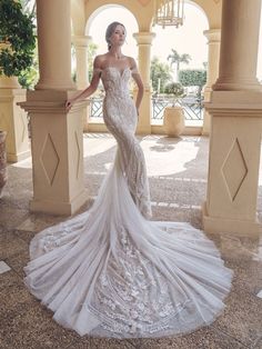 a woman in a wedding dress posing for the camera