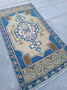 a blue and beige rug on the ground