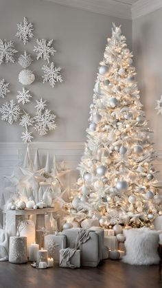 a white christmas tree surrounded by presents and snowflakes