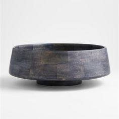 a wooden bowl sitting on top of a table