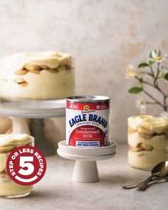 a can of eagle brand cake batter sitting on top of a white cake stand next to two cakes