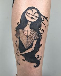 a woman's leg with a cartoon character tattoo on the side of her thigh