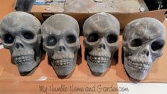 three skulls sitting on top of a cardboard box