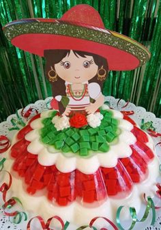 a cake decorated with red, green and white icing on top of a table