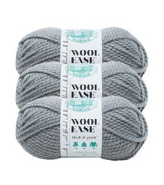 three skeins of wool - ease yarn in grey