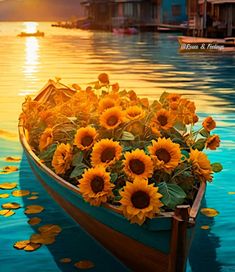 a row boat filled with lots of sunflowers floating on top of a lake