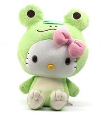 a green hello kitty stuffed animal with a pink bow on it's head and eyes