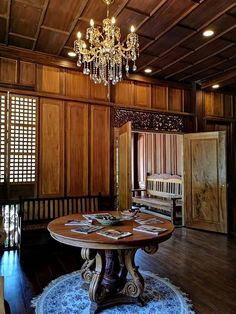 an ornate dining room with wood paneling and chandelier hanging from the ceiling