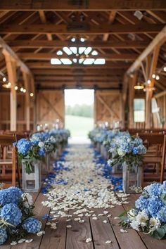 the aisle is lined with blue and white flowers