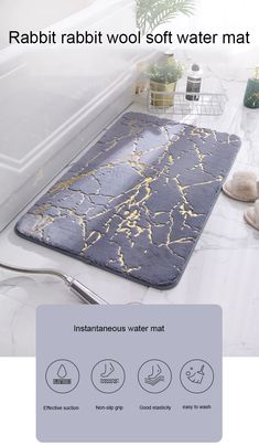 a bathroom rug with gold paint on it and the text rabbit rabbit soft water mat