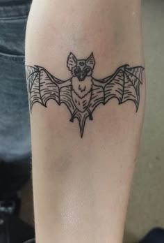 a small bat tattoo on the leg