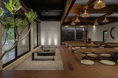 an empty restaurant with wooden tables and benches