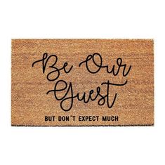 a door mat that says be our guest but don't expect much on it