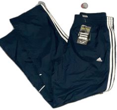 Sporty Blue Sweatpants With Three Stripes Branding, Blue Sporty Sweatpants With Three Stripes Branding, Blue Activewear For Jogging With Three Stripes, Blue Adidas Activewear For Jogging, Adidas Blue Activewear For Streetwear, Adidas Blue Activewear With Three Stripes, Casual Navy Bottoms For Sports Season, Blue Sweatpants With Three Stripes For Streetwear, Blue Sports Bottoms With Three Stripes