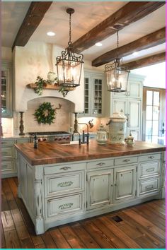 a large kitchen with an island in the center and two lights hanging from the ceiling