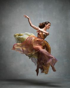 a woman in a dress is flying through the air