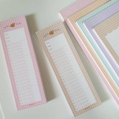 three pink and white checkered paper with numbers on them