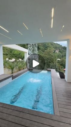 an indoor swimming pool surrounded by wooden decking