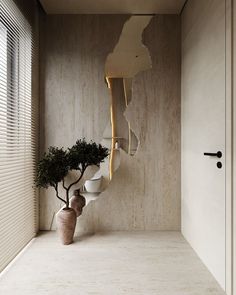 a vase with a tree in it next to a wall