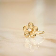 a close up of a flower ring on a table