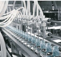 bottles are lined up on the assembly line