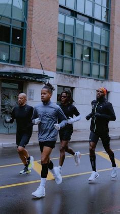 people running in the street on a rainy day