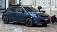 a blue car is parked on the street