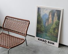 a chair sitting next to a painting on the wall