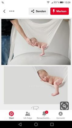 a baby laying on top of a white bed next to a person holding it's leg