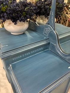 a blue painted dresser with flowers in the mirror on it's sides and an inscription that reads rebab 2 fad designs