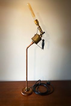 a lamp that is sitting on top of a wooden table next to a charger