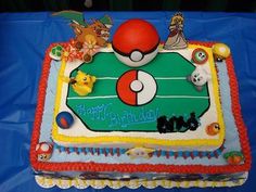 a pokemon themed birthday cake on a blue tableclothed cloth with an image of pikachu and pokeball