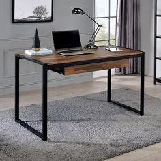 a desk with a laptop on it in front of a book shelf and window sill