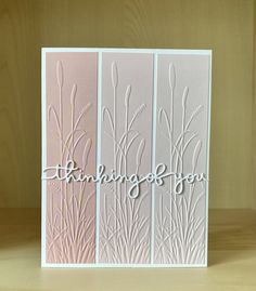 a white card with the words thinking on it and some grass in front of it