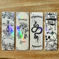 four bookmarks with different designs on them sitting on a table next to each other