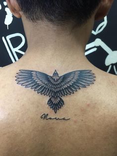 the back of a man's neck with an eagle tattoo on it