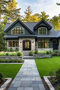 a large house with lots of windows and stone steps leading up to the front door