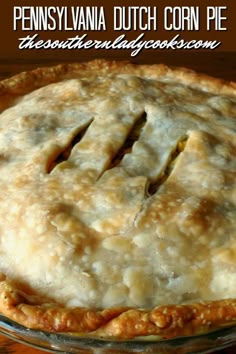 a pie sitting on top of a wooden table with the words pennsylvania dutch corn pie