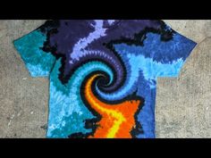 a tie - dyed t - shirt with an orange, blue and yellow spiral design