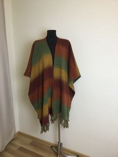 "Vintage Multicolor Knitted Cape Fringed Poncho Unisex Materials: no tag.Feels like Wool Vintage condition excellent. One Size. Please rely on measurements. Measurements (lying flat): Length (with fringe): 37\"/ 94cm Length (without fringe): 34\"/ 86,5cm.See photo 8 Shoulder: 20\"/ 51cm.See photo 9 Width: 46\"/ 117cm. See photo 10 Please double check measurements to insure a proper fit. Please note that color may slightly vary from photos. SHIPPING  I ship worldwide via Priority mail (Latvijas P Multicolor Bohemian Wool Poncho, Multicolor Cape Shawl One Size, Multicolor Shawl Cape One Size, One Size Multicolor Shawl Cape, Multicolor One-size Shawl Cape, Casual Multicolor Fall Poncho, Multicolor Casual Shawl Poncho, Casual Multicolor Shawl Poncho, Casual Multicolor Cape For Fall