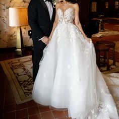 a man and woman in formal wear standing next to each other