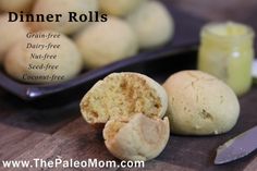 some food is sitting on a table next to a knife and bowl with the word dinner rolls