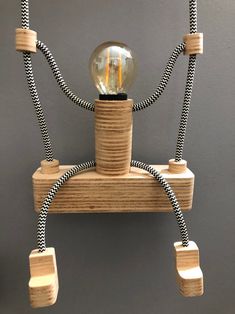 a light bulb is attached to a wooden shelf