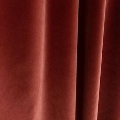 a close up view of a red velvet curtain