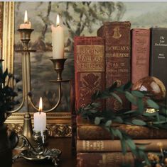 candles and books are sitting on a table