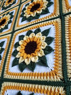 a crocheted blanket with sunflowers on it